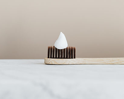 Toothbrush bristles shown as a comparison for the pluggy look of an old hair transplant